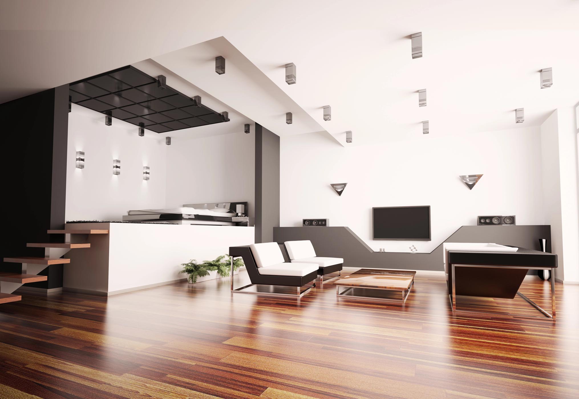 Modern living room with minimalist furniture, wood flooring, white walls, a TV, and an open kitchen area. Stairs lead up from the left side of the image.