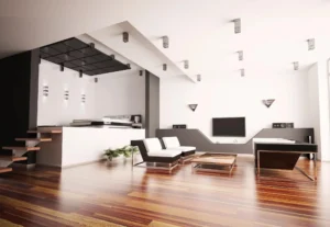 Modern living room with white furniture, wooden flooring, and sleek decor.