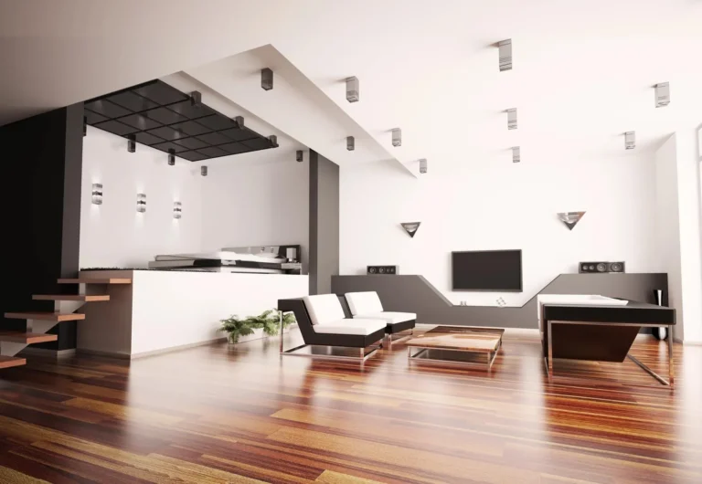 Modern living room with white furniture, wooden flooring, and sleek decor.